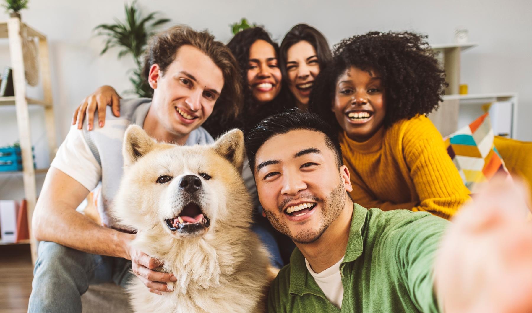 a group of people posing for a photo with a dog