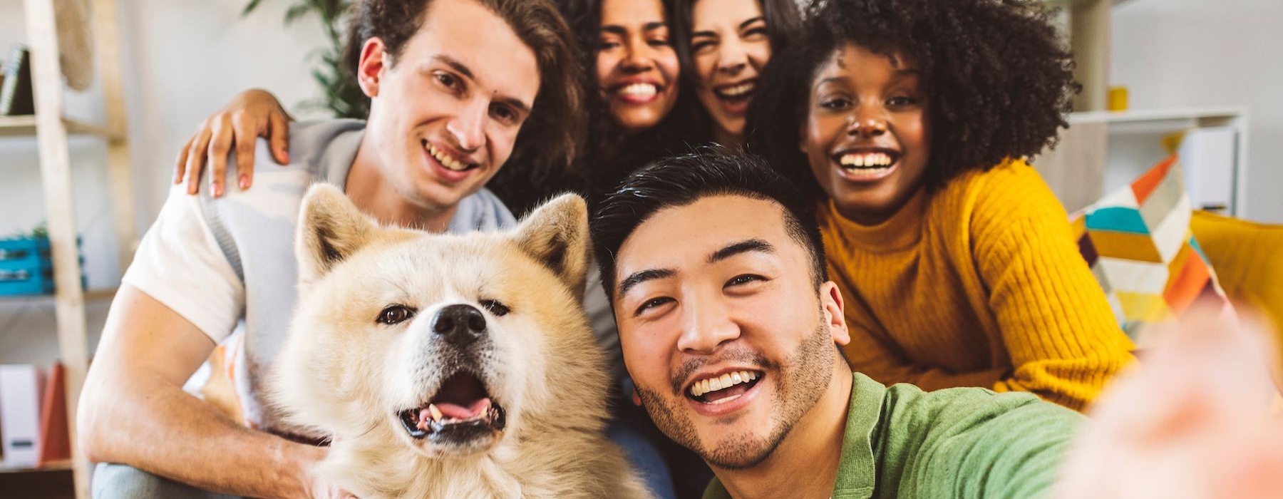 a group of people taking a picture with a dog