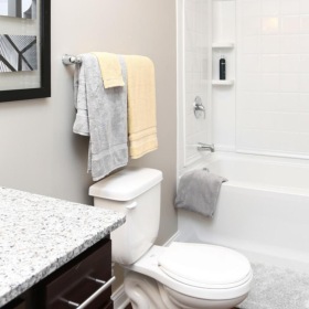 a bathroom with a tub, toilet and sink